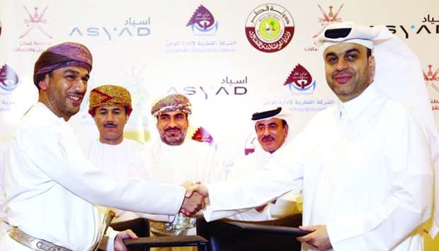 Mwani Qatar CEO Captain Abdulla al-Khanji and Asyad CEO Abdulrahman Salim al-Hatmi shake hands after signing the MoU in the presence of HE the Minister of Transport and Communications Jassim Seif Ahmed al-Sulaiti and Omanu2019s Minister of Transport and Communications Dr Ahmed bin Mohamed bin Salem al-Futaisi. PICTURE: Jayan Orma