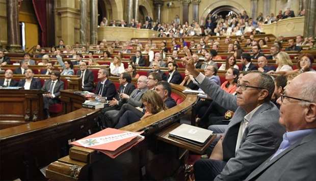 ,Catalunya si que es pot, (Catalonia, yes it can) political party spokesman, Joan Coscubiela (2R) votes during a session at the Catalan parliament in Barcelona