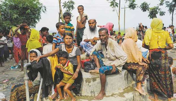 Rohingya refugees from Myanmaru2019s Rakhine state look on after arriving near the Khanchon border crossing near the Bangladeshi town of Teknaf.