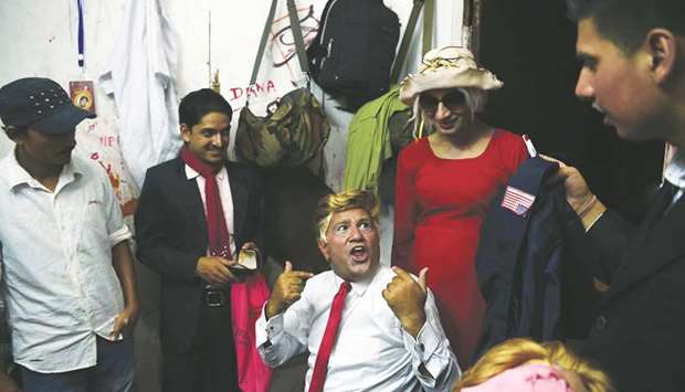 Comedian Manoj Gajurel, centre, prepares for a show impersonating US President Donald Trump in Kathmandu.