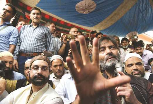 Separatist leaders Mirwaiz Umar Farooq (left) and Yasin Malik speak during a press conference outside Jamia Masjid in Srinagar yesterday.