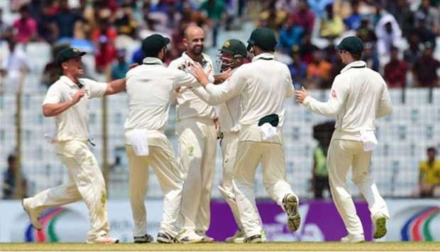 Australian cricketers congratulate Nathan Lyon (second right) after he claimed a wicket during the fourth day of the second Test against Bangladesh in Chittagong on Thursday.
