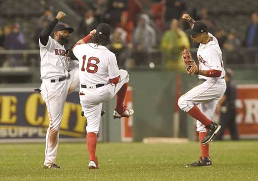 Boston Red Soxu2019s Andrew Benintendi (centre), Jackie Bradley Jr. (left) and Mookie Betts celebrate their win over the Toronto Blue Jays at Fenway Park in Boston, Massachusetts, on Wednesday. (USA TODAY Sports)
