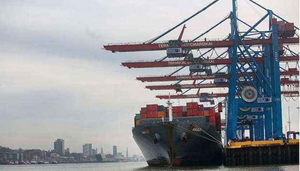 A container ship is moored beside ship-to-shore cranes at Hamburg port. u201cGermanyu2019s overall surplus is mainly caused by trade flows,u201d Ifo said, adding stronger demand from other eurozone countries, the rest of the EU and the US had boosted exports in the first half of the year.