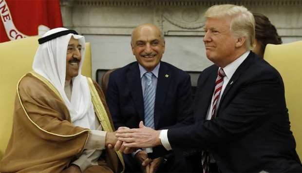 US President Donald Trump (R) welcomes Emir of Kuwait Sheikh Sabah al-Ahmad al-Jaber al-Sabah  (L) in the Oval Office at the White House in Washington