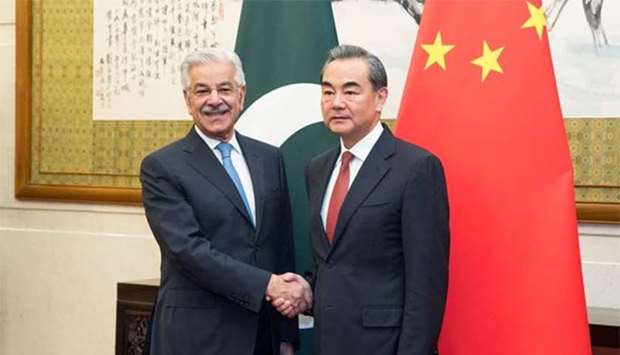 Chinese Foreign Minister Wang Yi shakes hands with Pakistan Foreign Minister Khawaja Muhammad Asif at Diaoyutai State Guesthouse in Beijing on Friday.