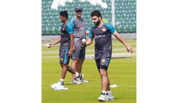 Pakistan coach Mickey Arthur (centre) watches bowlers Hasan Ali (left) and Usman Shinwari during a practice session at the Gaddafi Cricket Stadium in Lahore yesterday. (AFP)