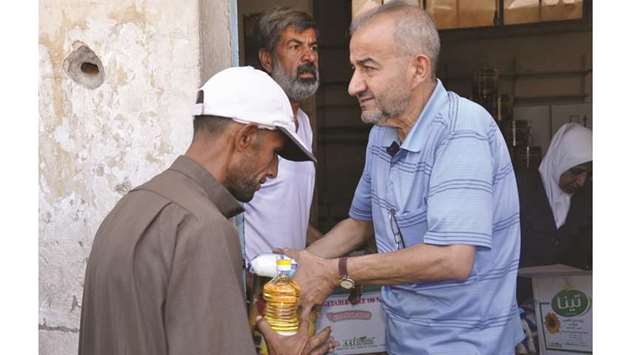 Residents of the northeastern Syrian city of Deir Ezzor receive aid parcels yesterday.
