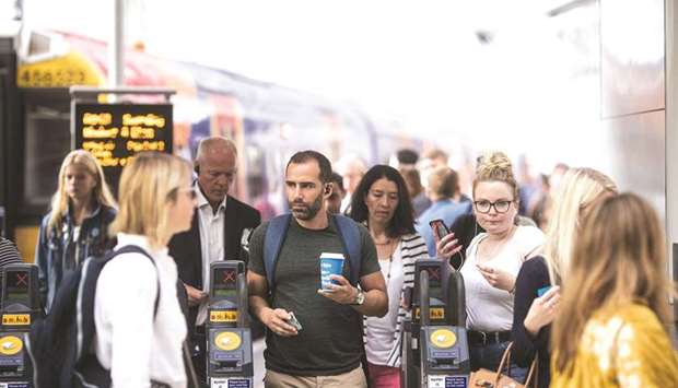 Commuters exit ticket barriers after arriving at London Waterloo railway station. Official figures suggested the UK, the worldu2019s fifth-biggest economy, continued to lag the strong recovery in the eurozone and is now growing slowly in the third quarter after suffering its slowest first half of the year since 2012.