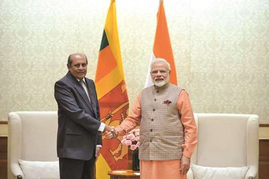 Sri Lankan Foreign Minister Tilak Marapana shakes hands with Indian Prime Minister Narendra Modi in New Delhi yesterday.