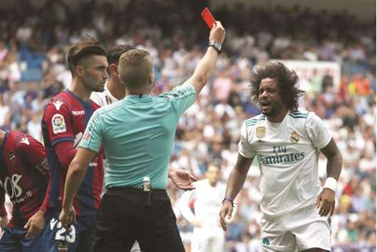 Real Madridu2019s Marcelo (R) is shown a red card by referee during the La Liga match against Levante. (Reuters)