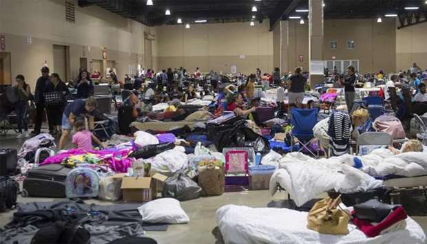 Hundreds of people gather in an emergency shelter at the Miami-Dade County Fair Expo Center in Miami