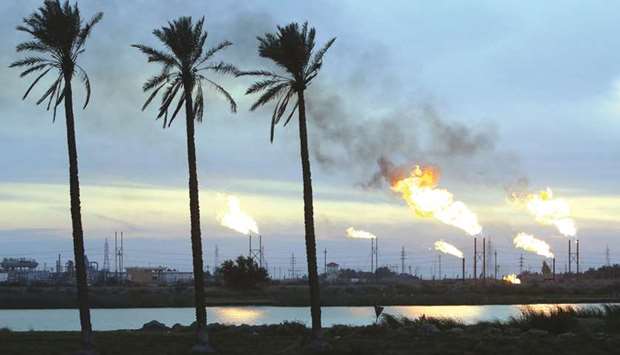 Flames emerge from flare stacks at the oil fields in Basra. Iraqu2019s crude exports reached a record of 3.59mn barrels a day, Oil Minister Jabbar al-Luaibi said after a meeting with representatives of foreign oil companies working in Iraq.