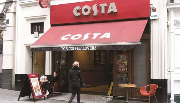 A customer enters a branch of a Costa coffee shop in London. Coca-Cola has agreed to buy Costa for $5.1bn to extend its push into healthier drinks and take on the likes of Starbucks and Nestle in the booming global coffee market.