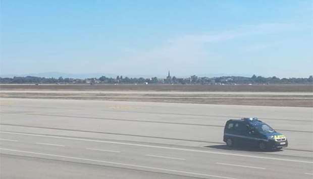 A French gendarmes vehicle speeds on the tarmac of Lyon's Saint-Exupery airport on Monday.