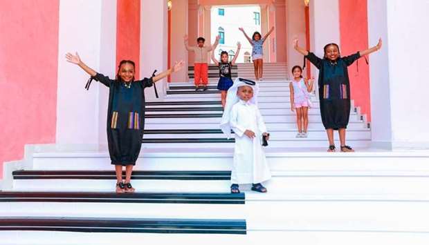 Children skip, hop and jump to play to play musical notes on Qanat Quartieru2019s Music Steps at The Pearl-Qatar.