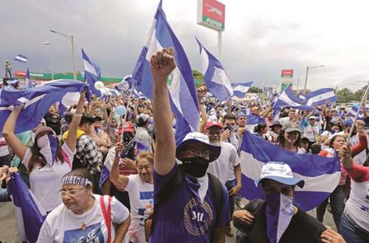Demonstrators shout slogans during a march against Nicaraguan President Daniel Ortegau2019s government in Managua yesterday.