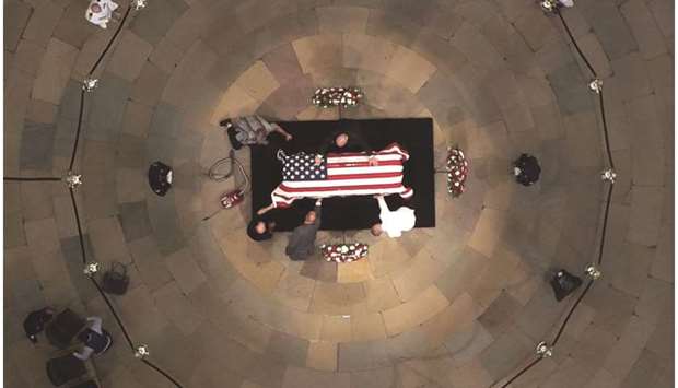 Workers clean the casket of the late US Senator McCain as he lies in state in the US Capitol Rotunda yesterday.