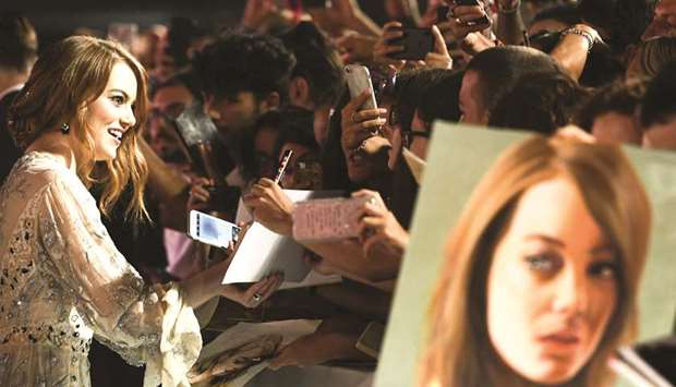 US actress Emma Stone signs autographs for fans as she  arrives on Thursday evening for the screening of the film The Favourite, presented in  competition at the 75th Venice Film Festival.