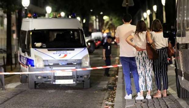 Police secure the area after seven people were wounded in a knife attack in Paris, on Monday.