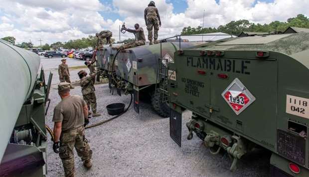 South Carolina National Guard soldiers transfer bulk diesel fuel into fuel tanker trucks for distribution in advance of Hurricane Florence