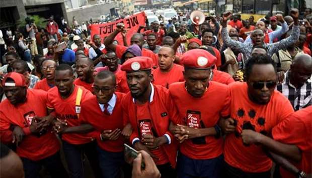 Robert Kyagulanyi (centre) leads activists during a demonstration in Kampala in July. File picture