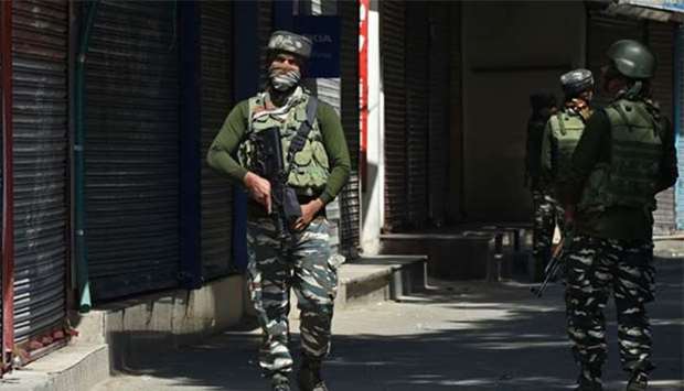 Indian paramilitary troopers patrol during a strike in Srinagar on Thursday.