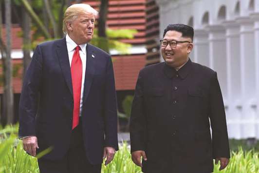 North Koreau2019s leader Kim Jong-un walks with US President Donald Trump during a break in talks at their historic US-North Korea summit, at the Capella Hotel on Sentosa island in Singapore earlier this year.