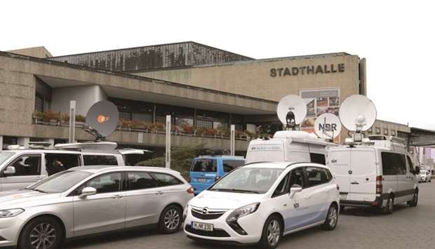 Media cars stand in front of the town hall during the Model Case Act trial involving Volkswagen and Porsche and German Capital Markets in Braunschweig, Germany, on Monday. Presiding Judge Christian Jaede took issue with VWu2019s longstanding claim that it put off disclosure of the US diesel probe because its lawyers had said fines were unlikely to affect the share price. The judge cited an August 2015 letter by law firm Kirkland & Ellis, and said the lawyers tried to be vague but discussed the potential penalties.