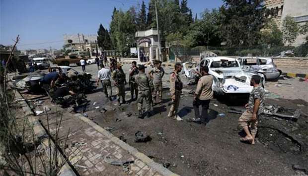 Free Syrian Army members inspect damaged cars after a car bomb in Azaz on Saturday.