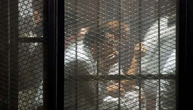 Detainees inside the soundproof glass dock of the courtroom during the trial of 700 defendants including Egyptian photojournalist Mahmoud Abu Zeid, widely known as Shawkan, in the capital Cairo, last Saturday.