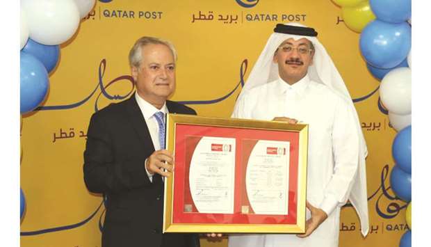 A top Qatar Post official receiving the ISO certification.