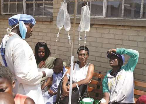 Patients await treatment at a makeshift cholera clinic in Harare.