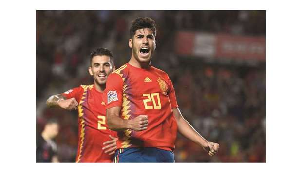 Spainu2019s midfielder Marco Asensio (right) celebrates with teammate Dani Ceballos after scoring a goal during the UEFA Nations League match against Croatia at the Manuel Martinez Valero stadium in Elche, Spain on Tuesday night. (AFP)