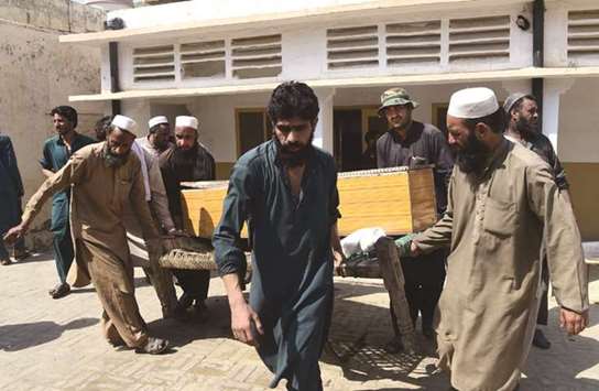Mourners carry the coffin of a miner killed during the collapsing of coal mine, in Darra Adam Khel town yesterday.