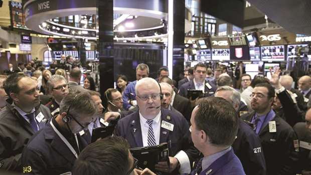 Traders work on the floor of the New York Stock Exchange (file). US-based mutual fund managers worried about the outlook for bank earnings have been trimming financial stocks from their portfolios, although some value-oriented portfolio managers and analysts said they still see attractive opportunities in the sector.