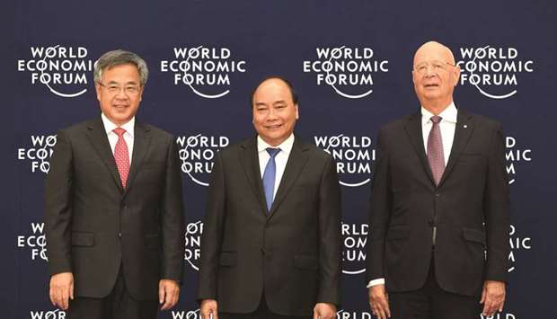 Chinese Vice Premier Hu Chunhua (left), Vietnamese Prime Minister Nguyen Xuan Phuc (centre) and Klaus Schwab, founder and executive chairman of the World Economic Forum, pose for photo during the Welcoming ceremony at the National Convention Centre in Hanoi, Vietnam. u201cSome individual countriesu2019 protectionist and unilateral measures are gravely undermining the rules-based multilateral trading regime, posing a most serious hazard to the world economy,u201d Hu said.