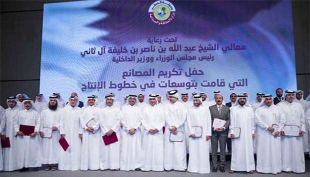 HE Sheikh Abdullah bin Nasser bin Khalifa al-Thani and HE Dr Mohamed bin Saleh al-Sada with the 45 owners and senior officials of manufacturing facilities who were honoured at the event.