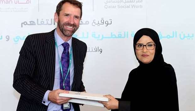 Sidra Medicine CEO Peter Morris and QFSW CEO Amal Abdullatif al-Mannai at the MoU signing ceremony on Thursday.