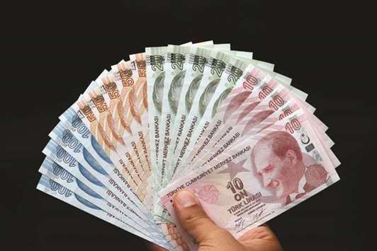 Turkish lira banknotes are seen in this picture illustration in Istanbul. The lira rallied 3% to 6.15 against the dollar after the rate decision, having traded at 6.4176 beforehand. It has still lost 38% of its value against the US currency this year.
