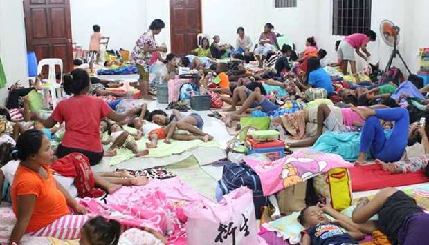 People are seen inside an evacuation centre in preparation for Typhoon Mangkhut in Cagayan, Philippines.