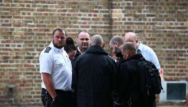 Prison officers stage a protest walkout outside Wormwood Scrubs Prison in London on Friday.