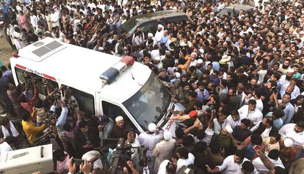 Supporters of the Pakistan Muslim League u2013 Nawaz (PML-N) gather around an ambulance  carrying the coffin of Kulsoom Nawaz during a funeral prayers ceremony in Lahore.