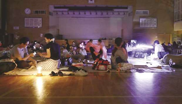 Evacuees are seen at a gymnasium of elementary school, acting as an evacuation shelter, during blackout after an earthquake hit the area in Sapporo, Hokkaido, northern Japan, in this file photo.