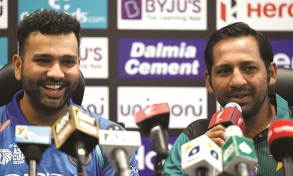 Pakistan captain Sarfraz Ahmed (right) speaks during an Asia Cup press conference as Indian captain Rohit Sharma looks on in Dubai yesterday. (AFP)