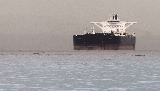 An Iranian crude oil supertanker Delvar is seen anchored off Singapore. Indian refiners will cut their monthly crude loadings from Iran for September and October by nearly half from earlier this year as New Delhi works to win waivers on the oil export sanctions Washington plans to reimpose on Tehran in November.
