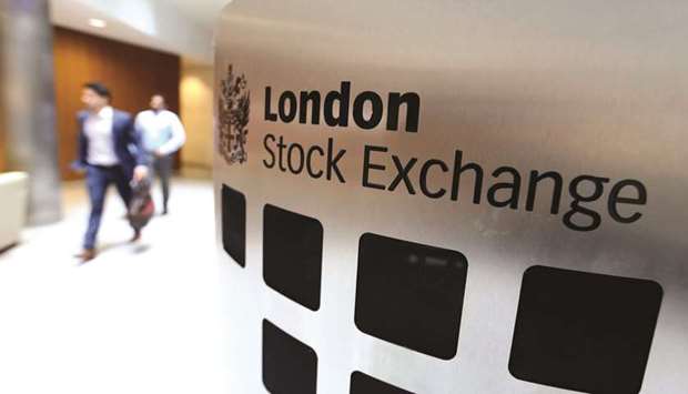 Visitors pass a sign inside the London Stock Exchange Group headquarters. The FTSE 100 closed 0.3% up at 7,304.04 points yesterday.