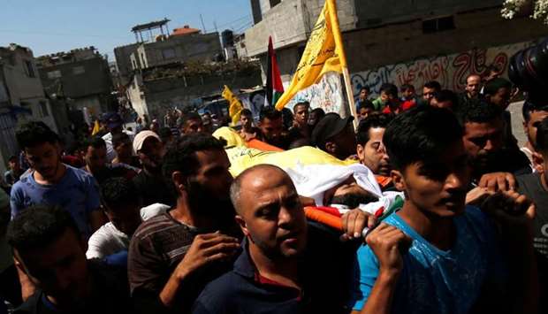 Palestinian mourners carry the body of 12-year-old Palestinian boy Shadi Abdel Aal, who was killed by Israeli forces during a protest at the Israel-Gaza border fence, during his funeral in Jabalia refugee camp in the northern Gaza Strip.