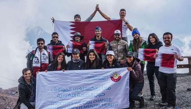 The group at the summit of Mount Elbrus raising Qatari flag with a number of Kuwaiti youth