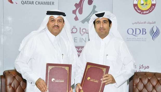 Qatar Chamber director general Saleh bin Hamad al-Sharqi and QIMC CEO Abdul Rahman Abdulla al-Ansari after signing the sponsorship agreement for the u2018Made in Qatar 2018u2019 exhibition slated from November 5 to 9 in Oman
